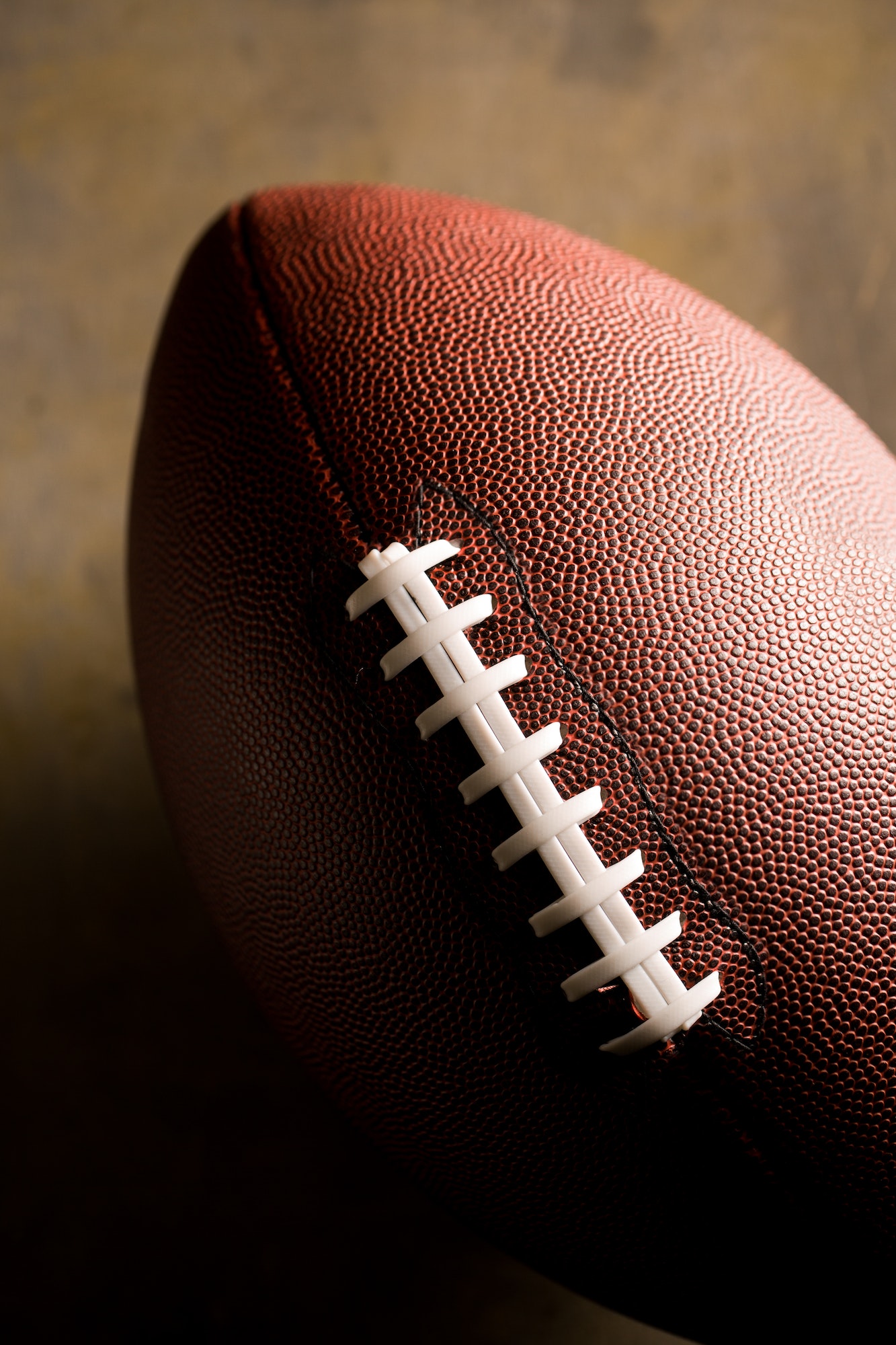 American football ball on dark background