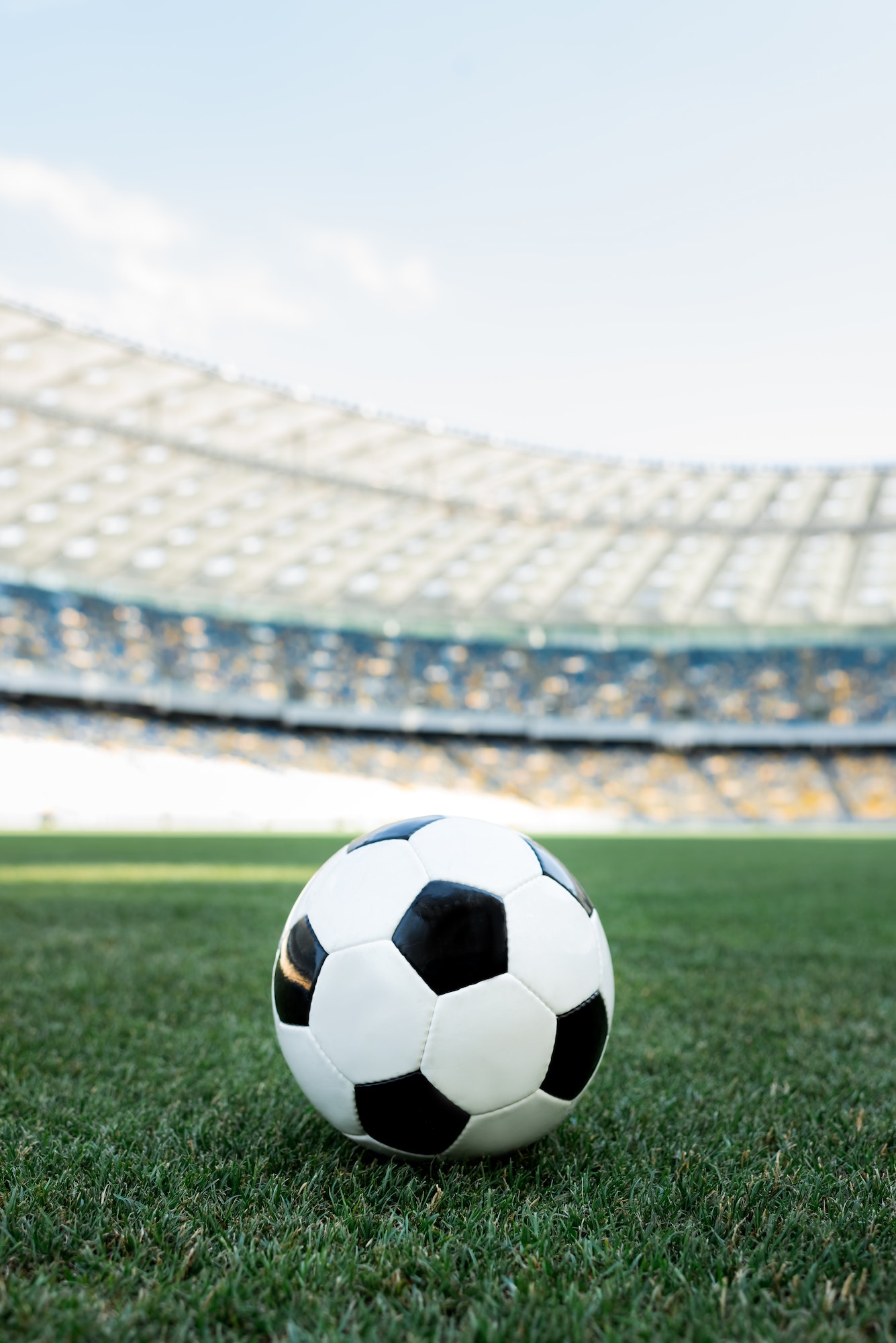 soccer ball on grassy football pitch at stadium